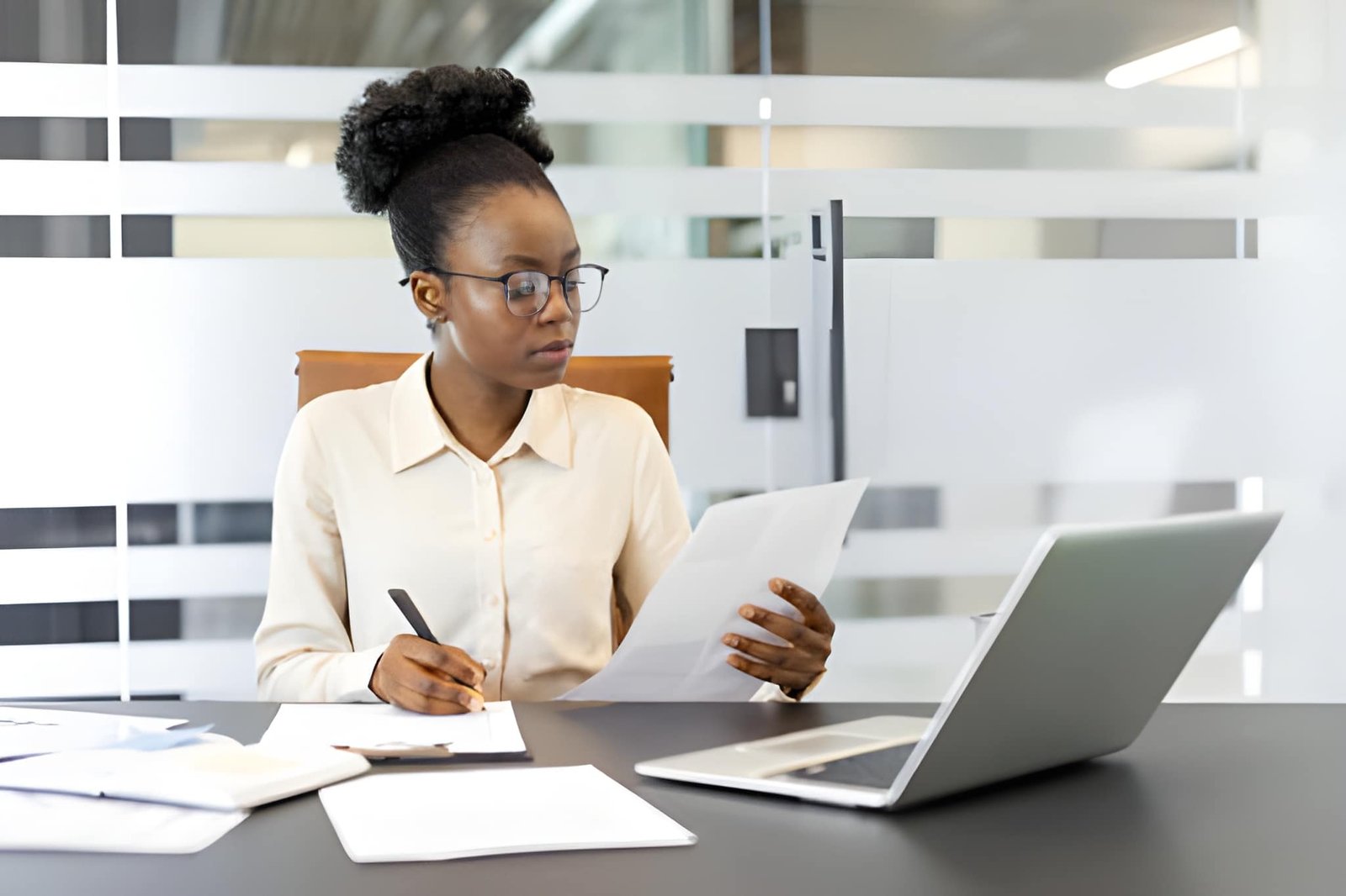 Professional reviewing paperwork at a desk